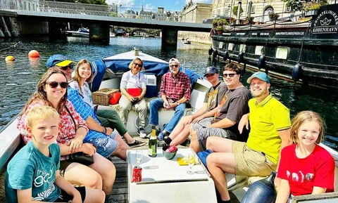 Small private boat on a Copenhagen boat charter cruising the canals