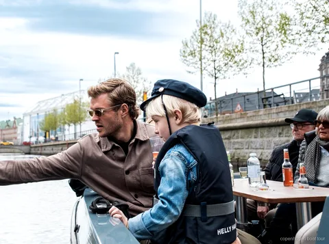 Lille gruppe passagerer på den elektriske kanaltur i København nær Nyhavn