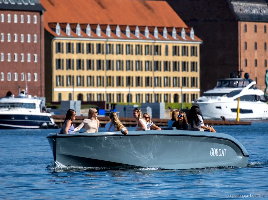 Capitaine guidant le tour électrique sur les canaux de Copenhague devant le palais d'Amalienborg